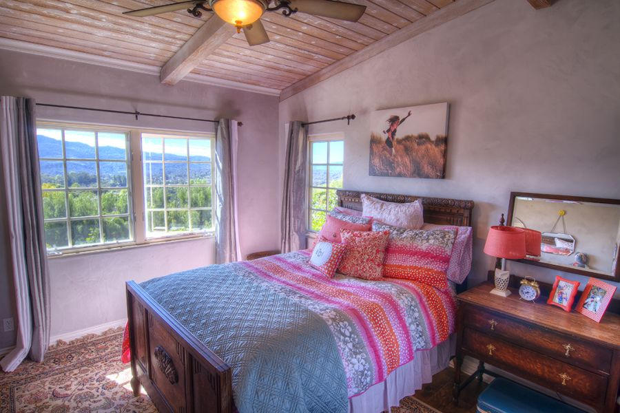302 Fairview Road Ojai, CA 93023 - Photo 25 of 28 a bedroom with a bed and a chandelier