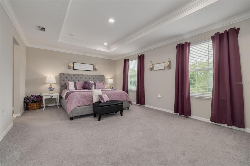 7242 Landmark Drive Spring Hill, FL 34606 - Photo 28 of 45 a bedroom with a bed and a lamp