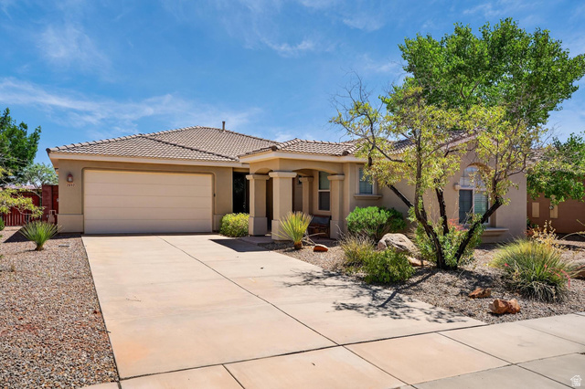2602 East Spring Canyon Drive Washington, UT 84780 - Photo 1 of 1 View of front of home featuring stucco siding, driveway, a garage, and a tile roof