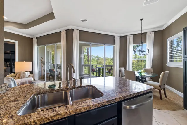 a kitchen with granite countertop a sink and a counter top space