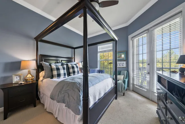 a bedroom with a bed and a large window