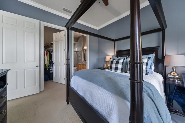 a bed room with a bed and a double vanity