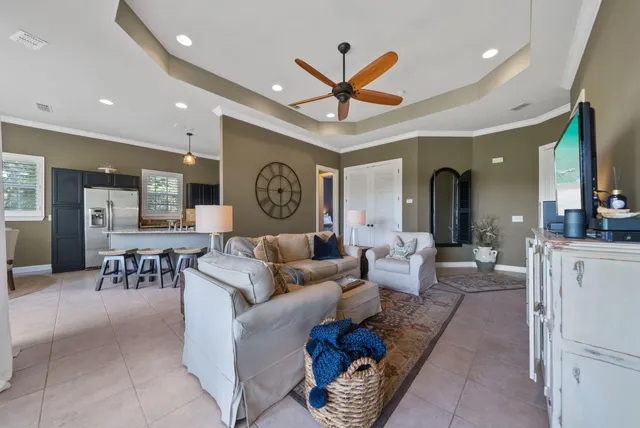a living room with furniture and a clock