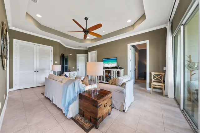 a living room with furniture and a view of kitchen