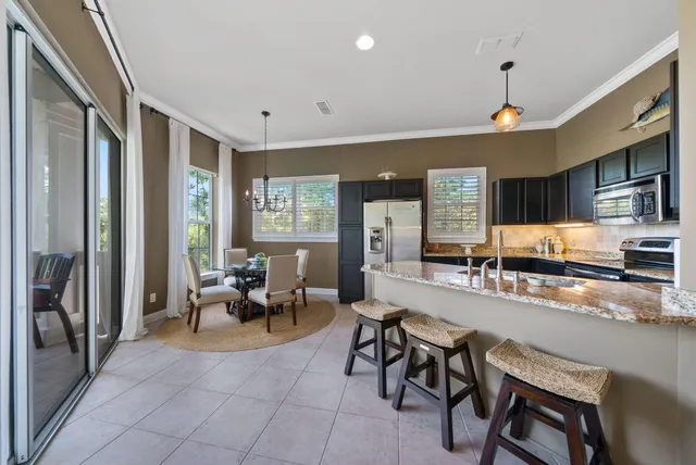 a large living room with stainless steel appliances granite countertop furniture a couch and a view of living room