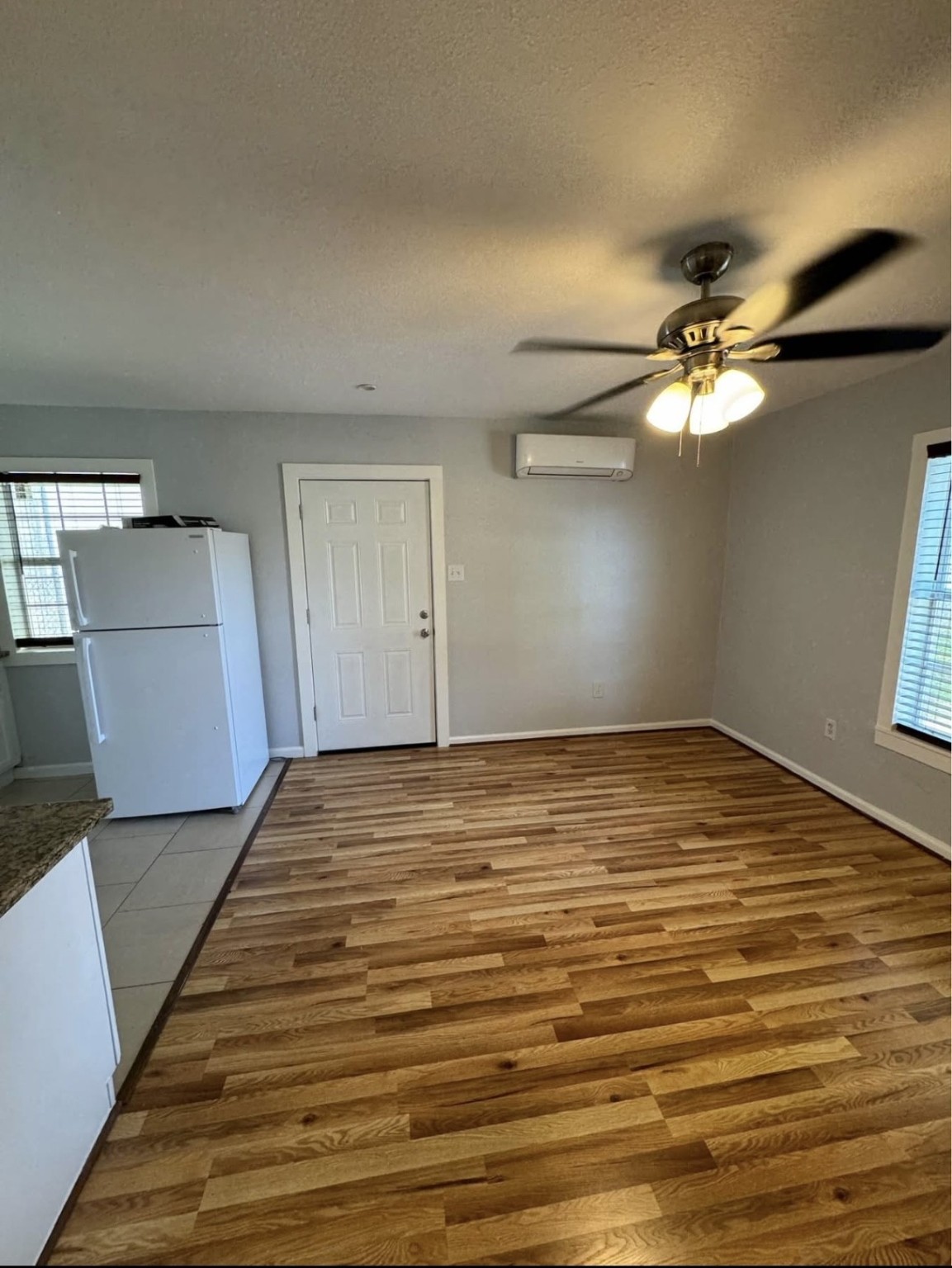 8416 La Porte Road Houston, TX 77012 - Photo 12 of 14 a view of a room with wooden floor and ceiling fan