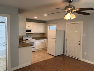 8416 La Porte Road Houston, TX 77012 - Photo 6 of 14 a kitchen with kitchen island granite countertop white cabinets and window