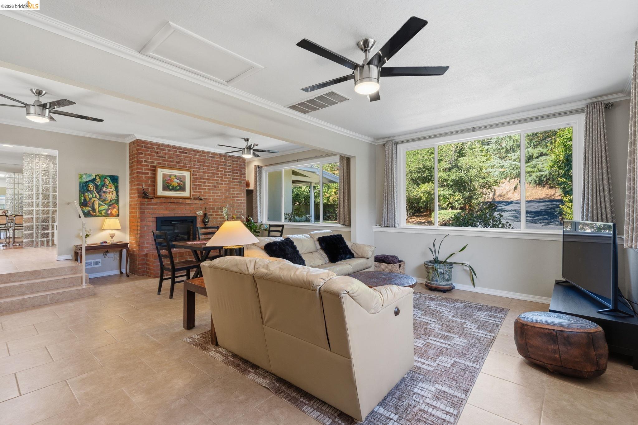 5075 Alhambra Valley Road Martinez, CA 94553 - Photo 18 of 68 Tiled flooring throughout, brick fireplace, expansive window, crown molding, and ceiling fans