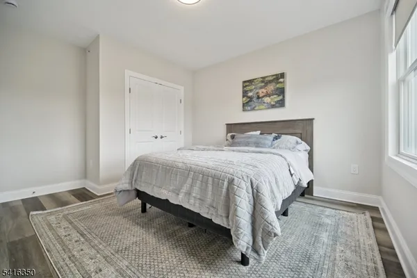 a bed sitting in a bedroom next to a window