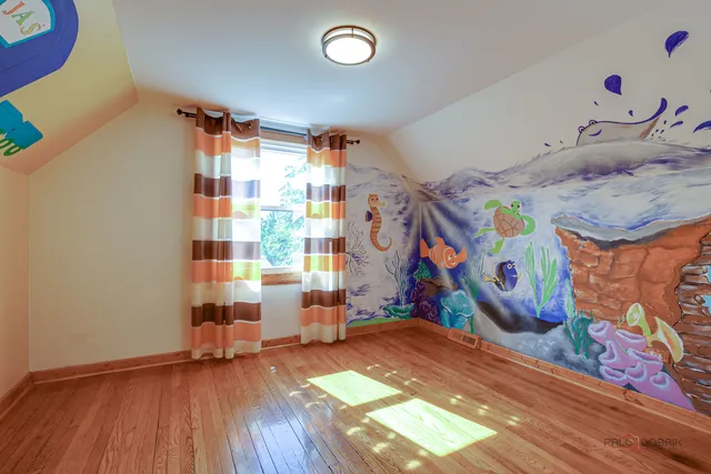 a view of room with window and wooden floor