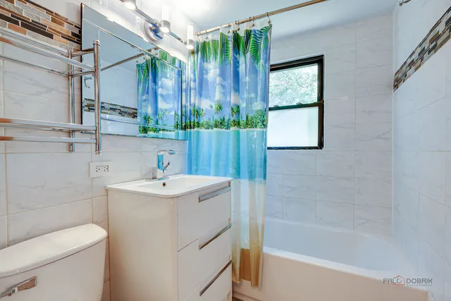 a bedroom with a bed and wooden furniture