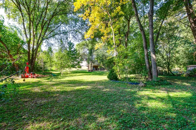 a view of a house with a yard and sitting area