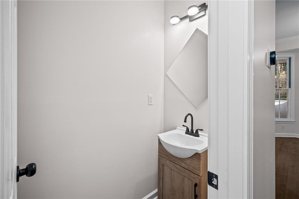 2250 Chickering Court Cumming, GA 30041 - Photo 11 of 25 a bathroom with a sink a mirror and shower