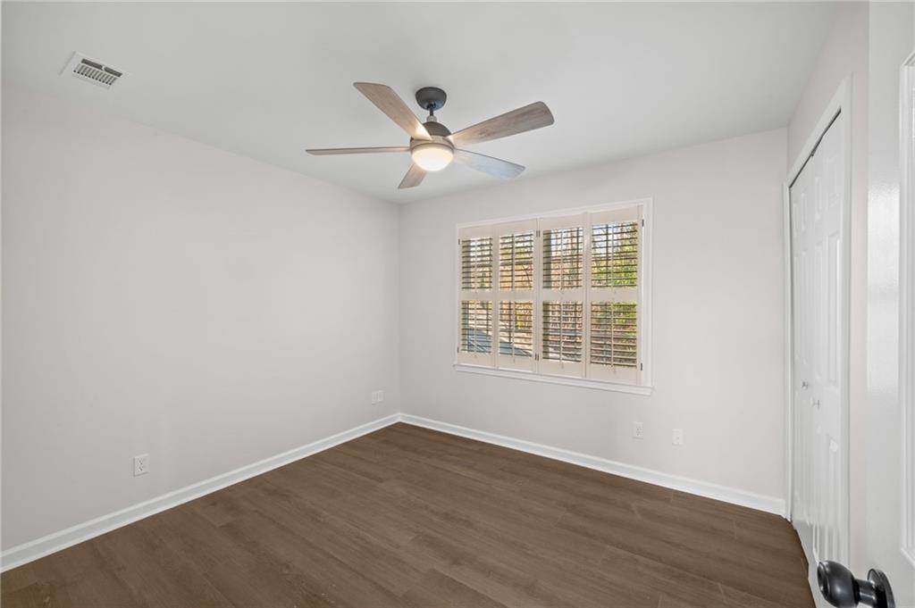 2250 Chickering Court Cumming, GA 30041 - Photo 15 of 25 a view of an empty room with wooden floor and a window
