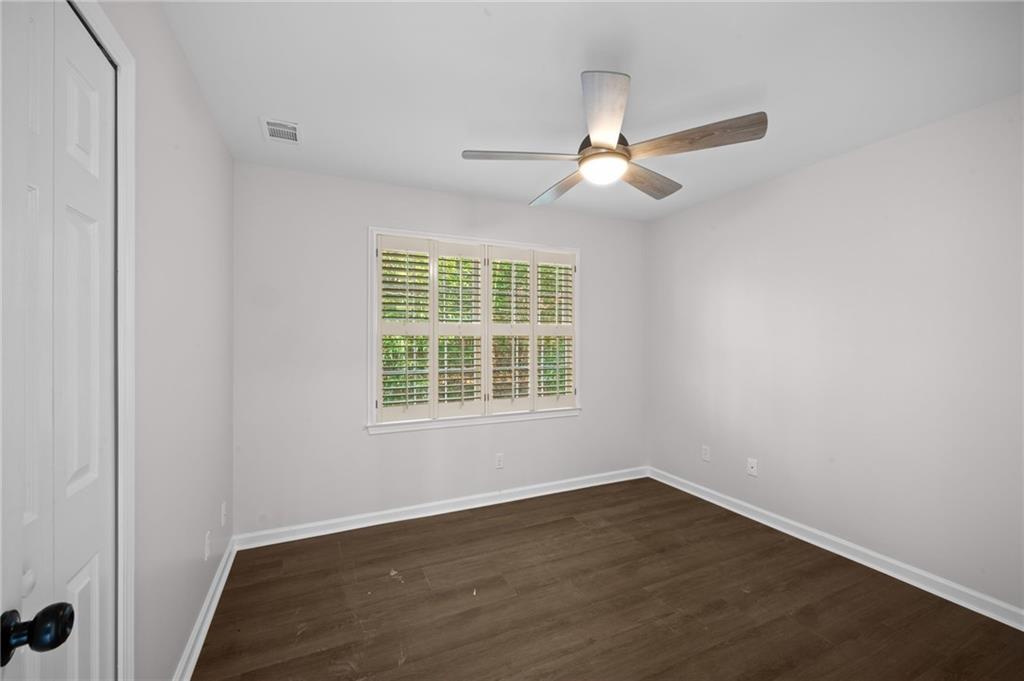 2250 Chickering Court Cumming, GA 30041 - Photo 17 of 25 an empty room with wooden floor fan and windows