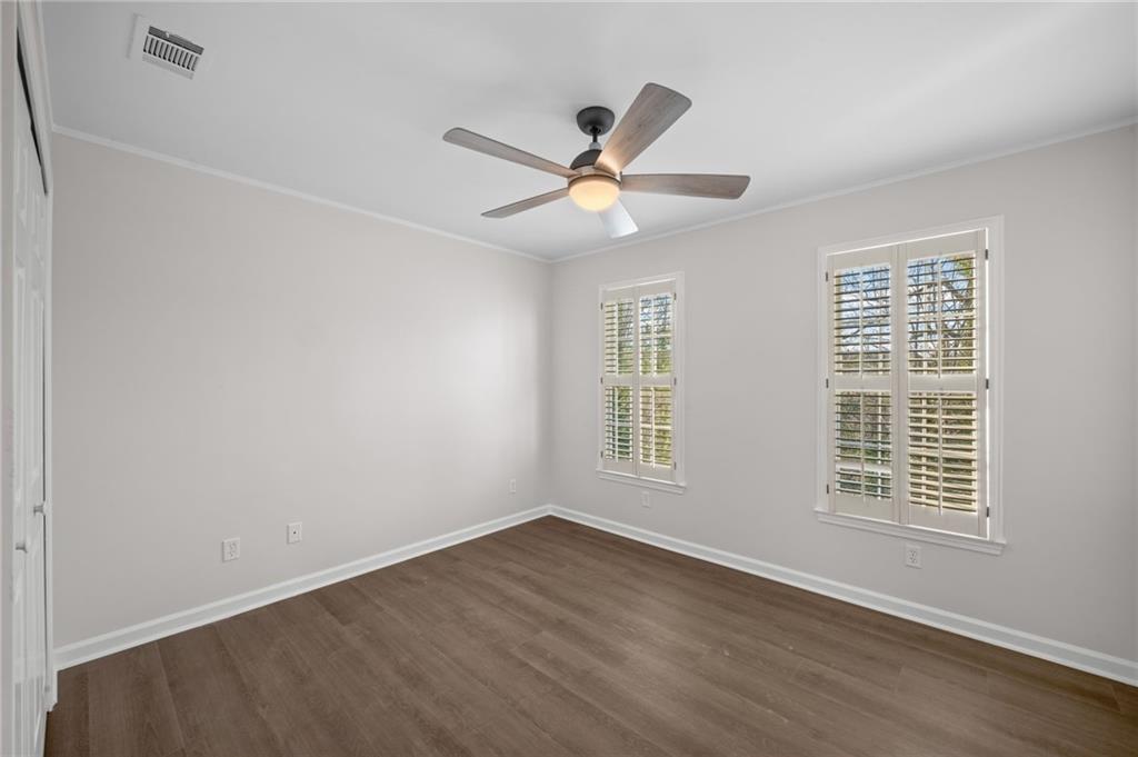 2250 Chickering Court Cumming, GA 30041 - Photo 19 of 25 a view of an empty room with a window and wooden floor