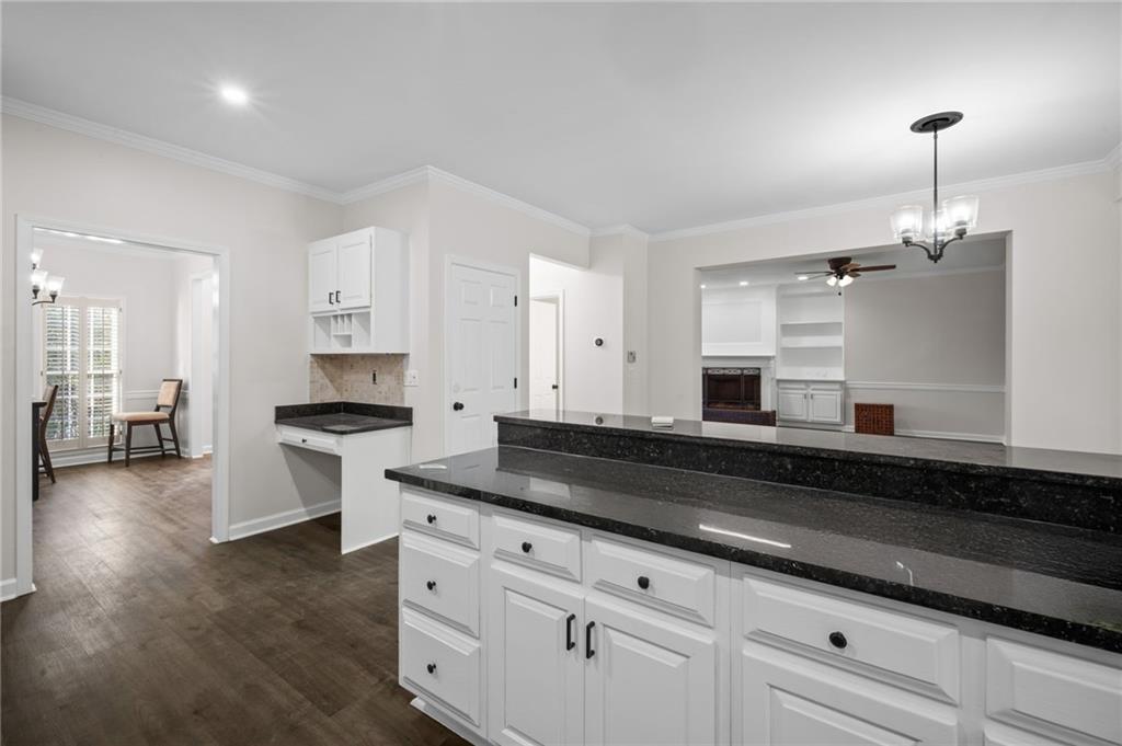 2250 Chickering Court Cumming, GA 30041 - Photo 7 of 25 a kitchen with granite countertop white cabinets and a granite counter tops