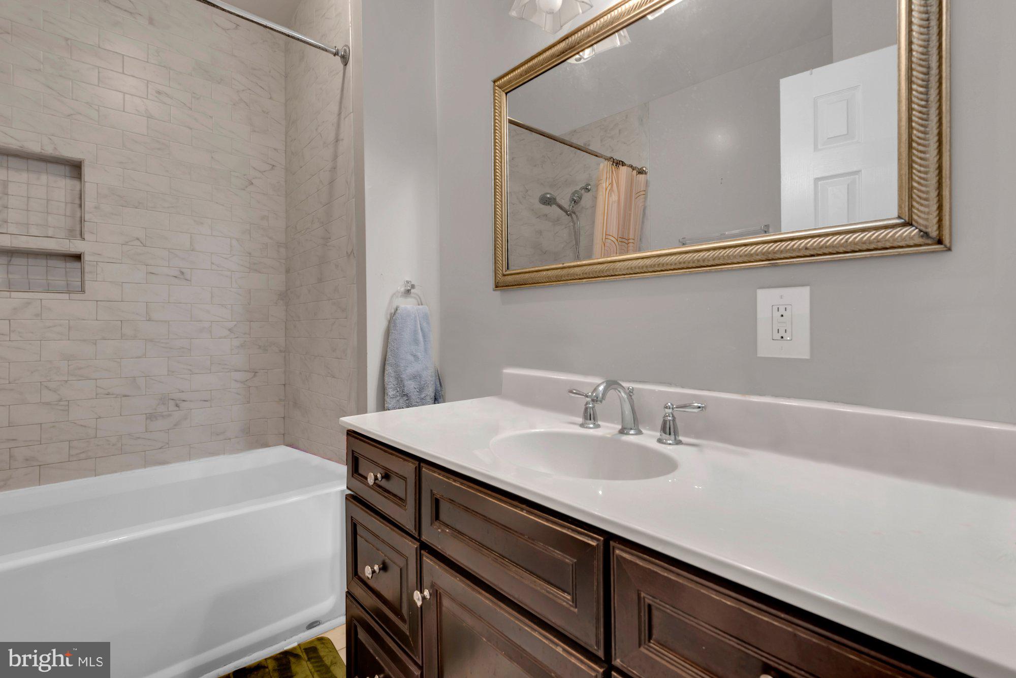 210 West Read Street Baltimore, MD 21201 - Photo 9 of 11 a bathroom with a sink a bathtub and a mirror