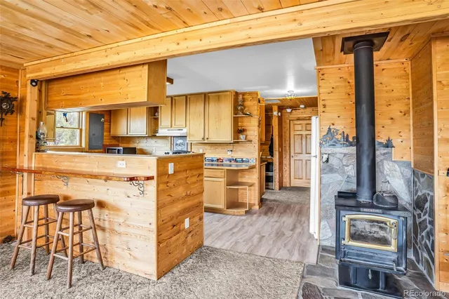 a kitchen with stainless steel appliances kitchen island granite countertop a refrigerator and a stove top oven