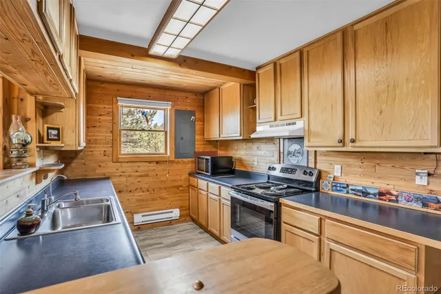 a kitchen with stainless steel appliances granite countertop a stove and a sink