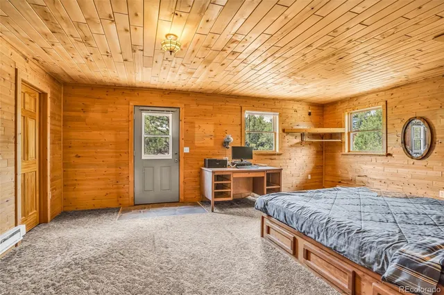 a bedroom with a bed and a desk