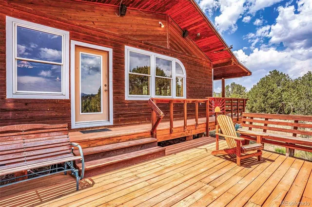 a balcony with view of trees in the background
