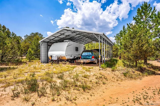 a backyard of a house with table and chairs