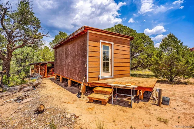 a balcony with table and chairs