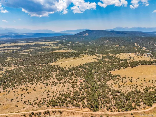 a view of a house with a yard and a mountain view