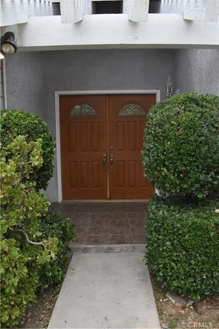 a front view of house with a garden