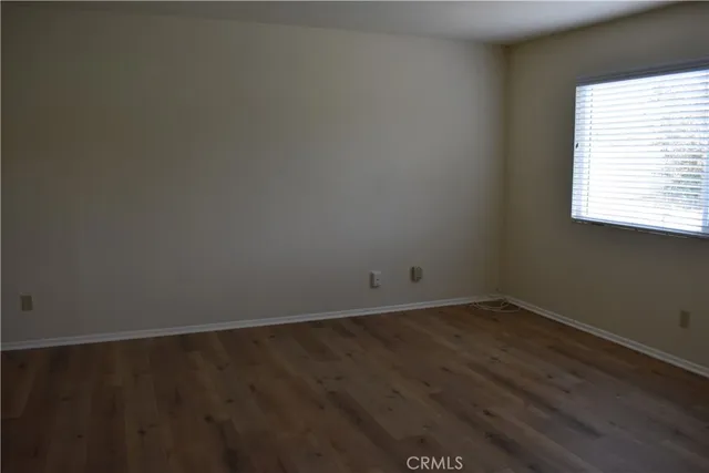 an empty room with wooden floor and closet