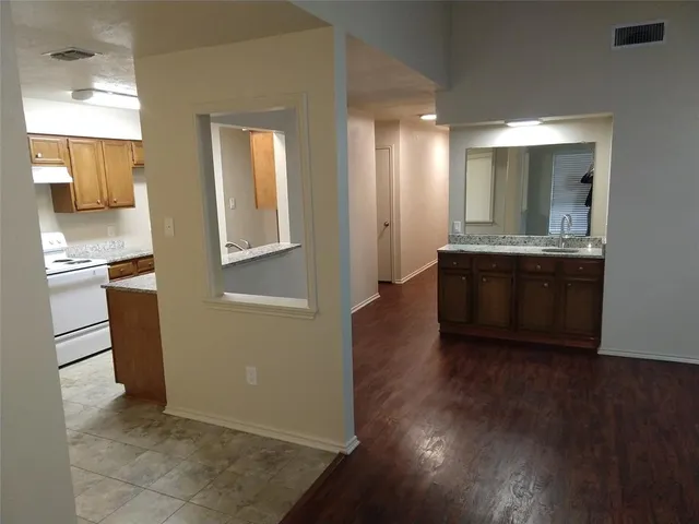 a view of a kitchen cabinets and wooden floor