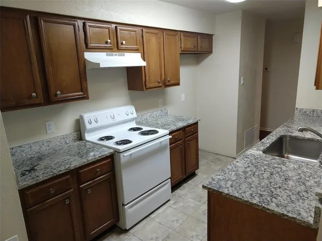 a kitchen with stainless steel appliances granite countertop a sink stove and cabinets