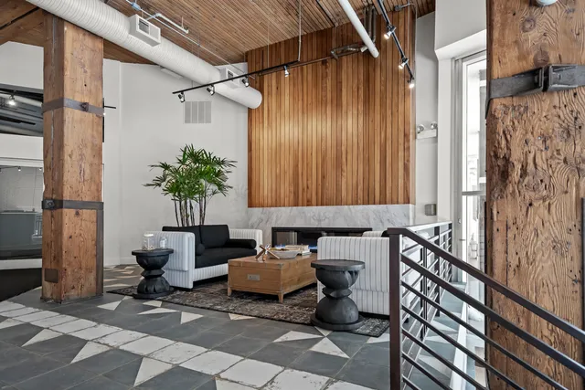 a living room with furniture and a potted plant
