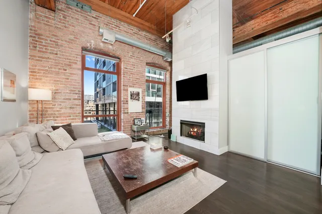 a living room with furniture a fireplace and a flat screen tv