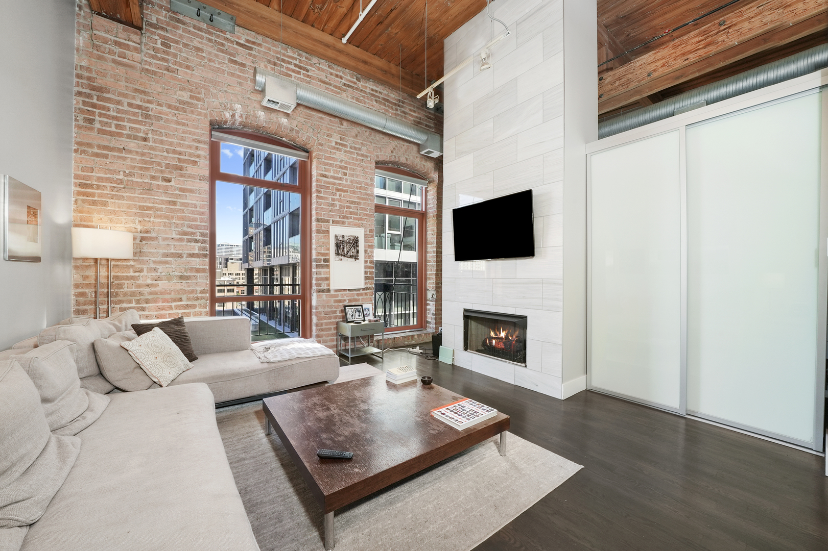 360 West Illinois Street, Unit 614 Chicago, IL 60654 - Photo 2 of 36 a living room with furniture a fireplace and a flat screen tv