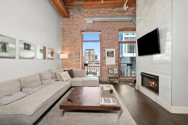 a living room with furniture a fireplace and a flat screen tv