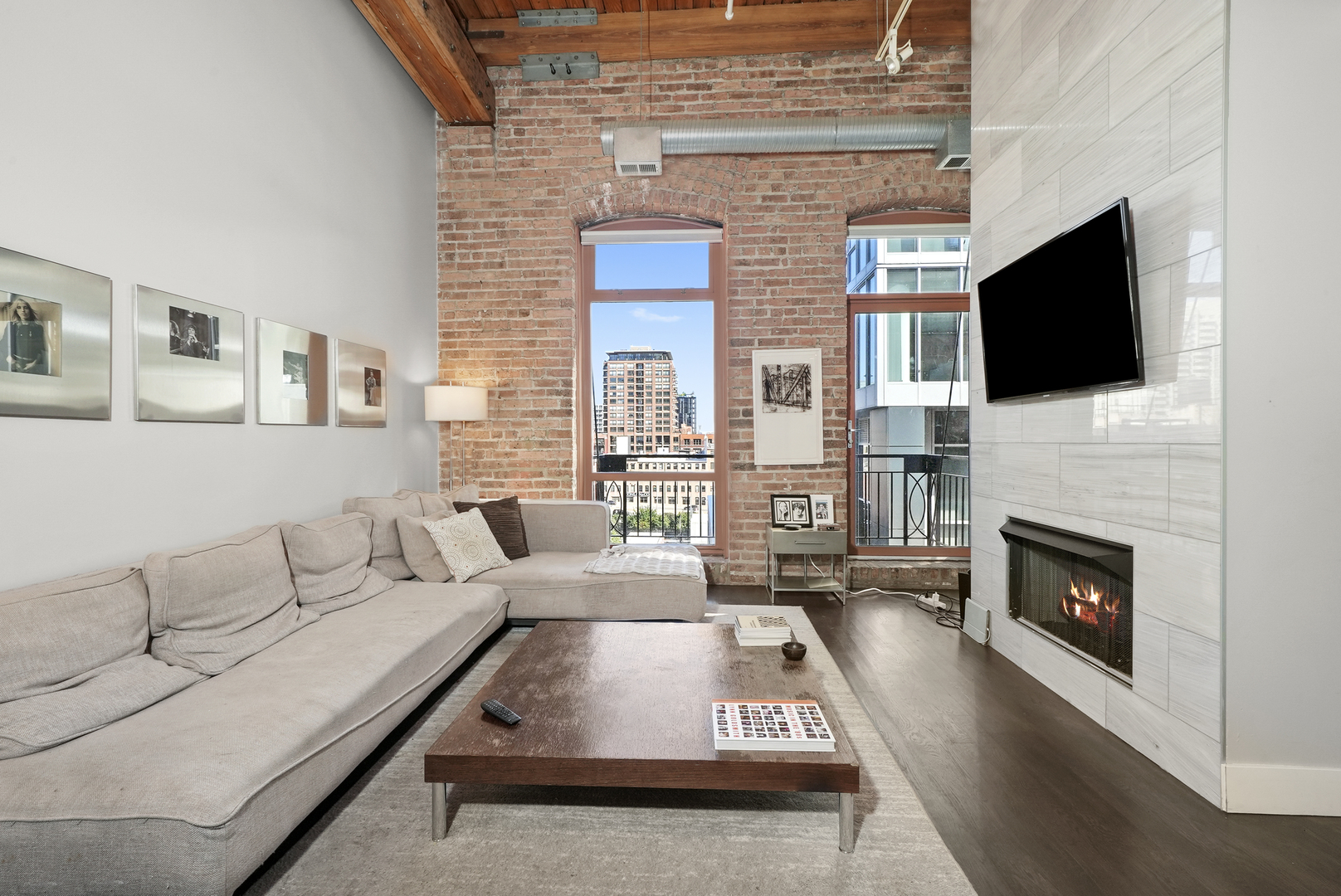360 West Illinois Street, Unit 614 Chicago, IL 60654 - Photo 3 of 36 a living room with furniture a fireplace and a flat screen tv