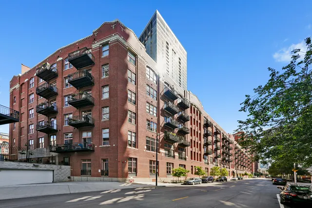 a view of a tall building next to a road