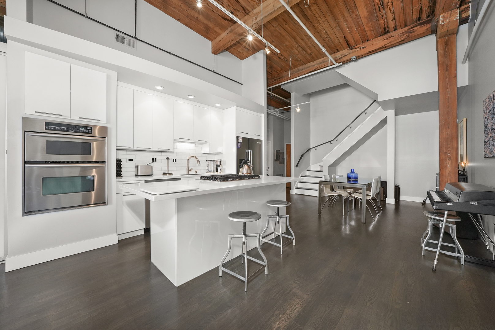 360 West Illinois Street, Unit 614 Chicago, IL 60654 - Photo 8 of 36 a kitchen with a table chairs refrigerator and cabinets