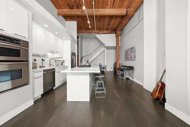 a kitchen with a white stove top oven and cabinets