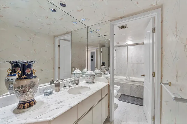 a bathroom with a granite countertop sink a toilet and shower
