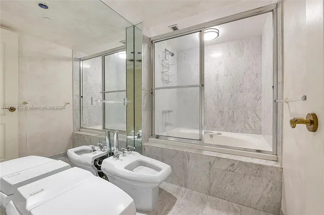 a bathroom with a toilet sink and shower