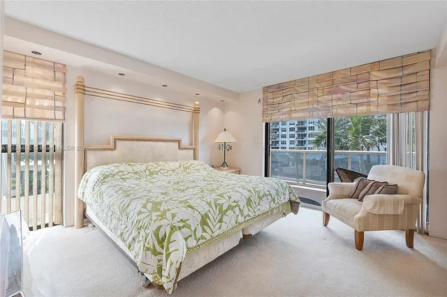 a bedroom with a large bed and a large window