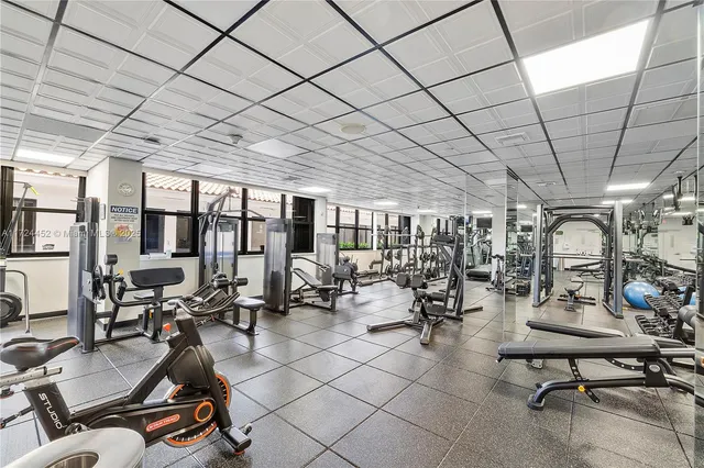 a living room with furniture a couch and a hockey table