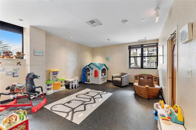 a living room with furniture and a book shelf