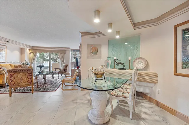 a dining room with furniture and a window