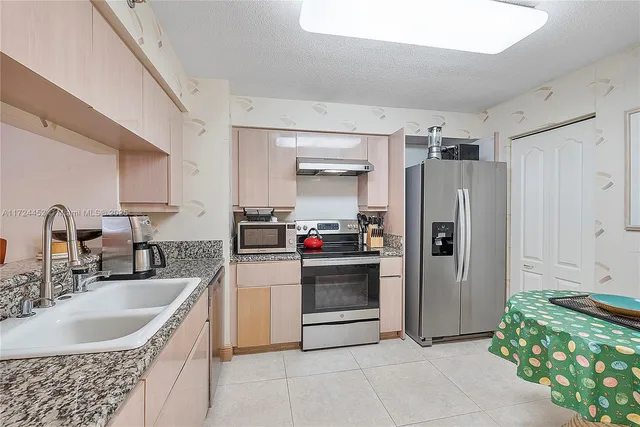 a kitchen with a sink cabinets and stainless steel appliances