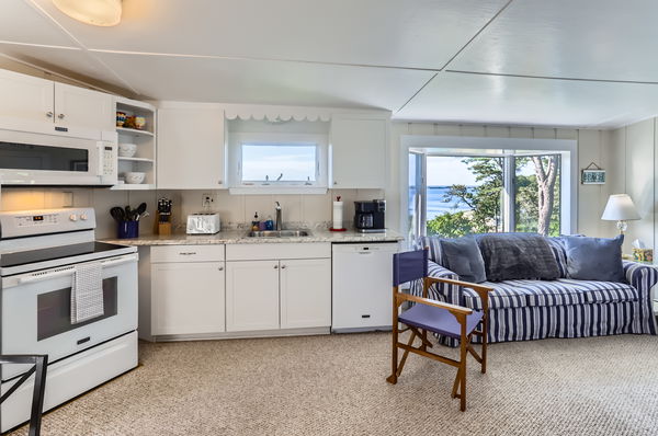 217 Barnes Road Oak Bluffs, MA 02557 - Photo 40 of 60 a kitchen with a white cabinets and chairs