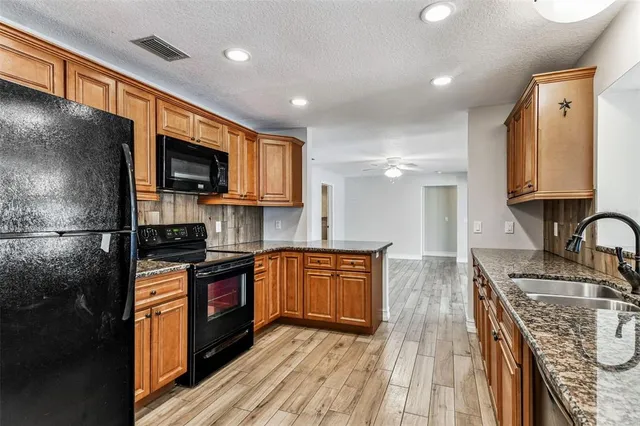 a view of a livingroom with wooden floor and furniture